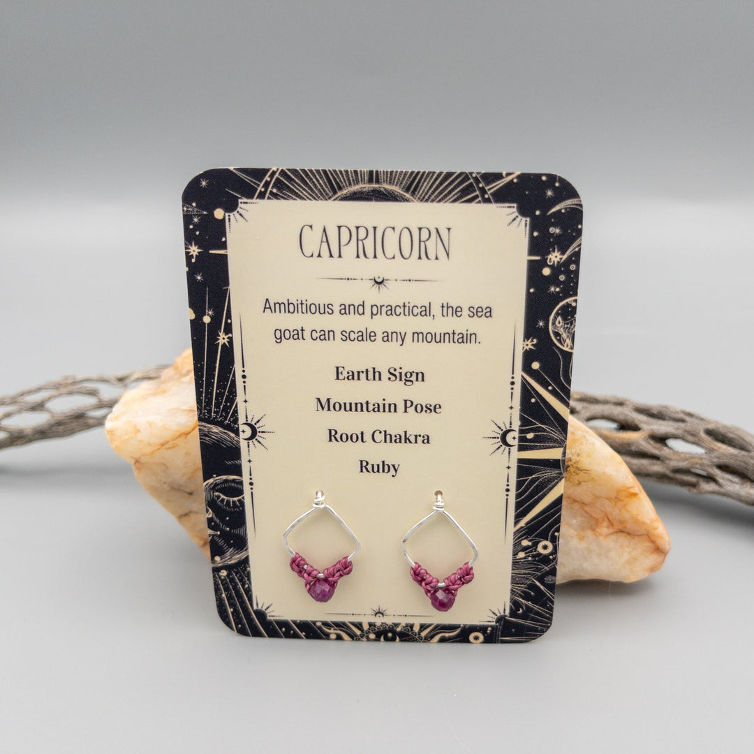 Capricorn ruby earrings in sterling silver showing the front of the card