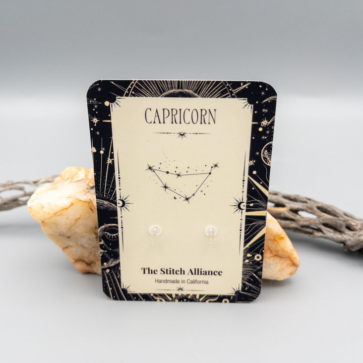 Capricorn ruby earrings in sterling silver showing the Capricorn constellation on the back of the card