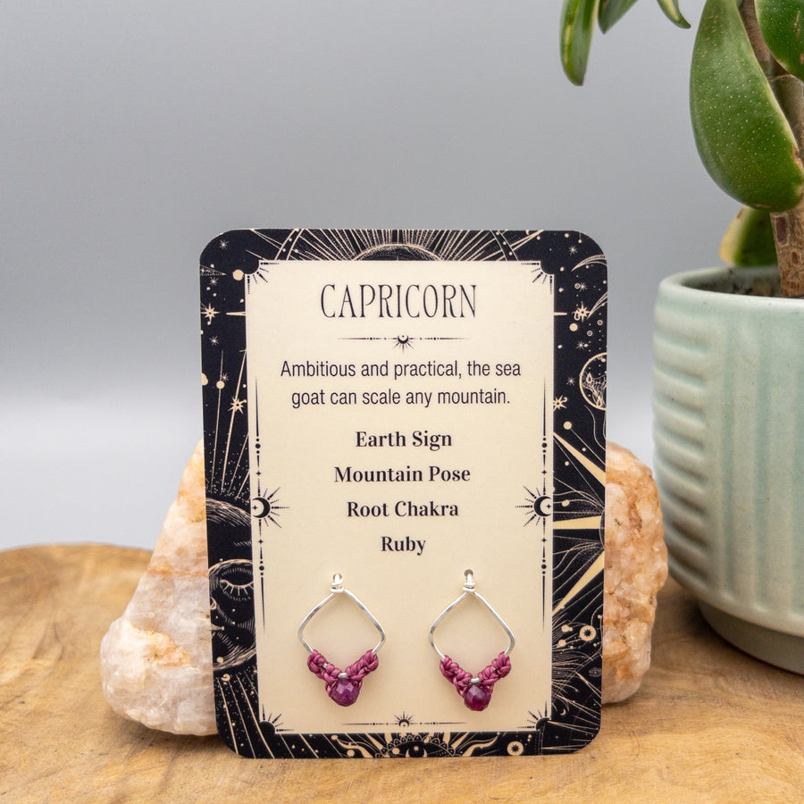 Capricorn ruby earrings in sterling silver on a gift card