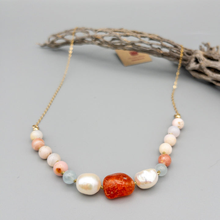 carnelian, freshwater pearl, aquamarine, and pink opal hand knotted necklace with a gold filled chain