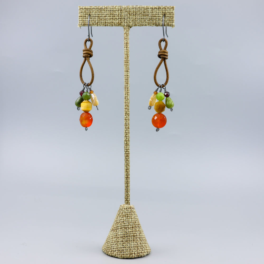 handmade gemstone charm earrings leather and oxidized sterling silver on a linen hanger