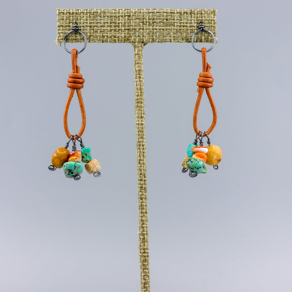 handmade turquoise, jasper, agate, and spiny oyster leather and oxidized sterling silver earrings on a linen hanger
