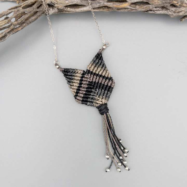 detail of black and gray macrame necklace with sterling silver chain