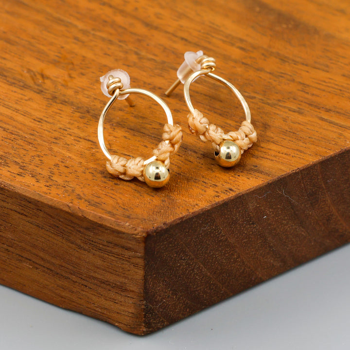handmade gold macrame stud earrings close up view
