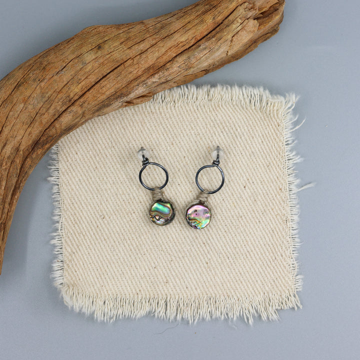 handmade abalone drop earrings with oxidized sterling silver on an off white background