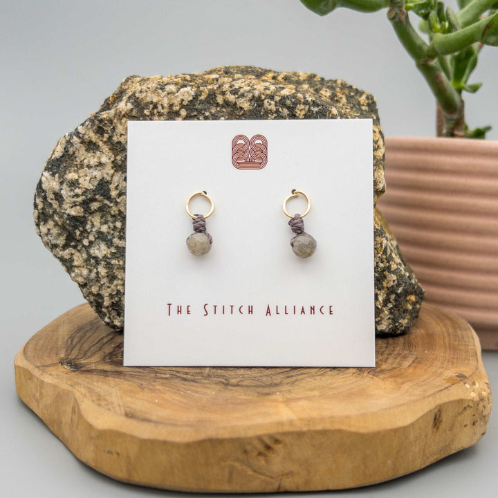 14k gold filled circle post earrings with a labradorite bead on a white card