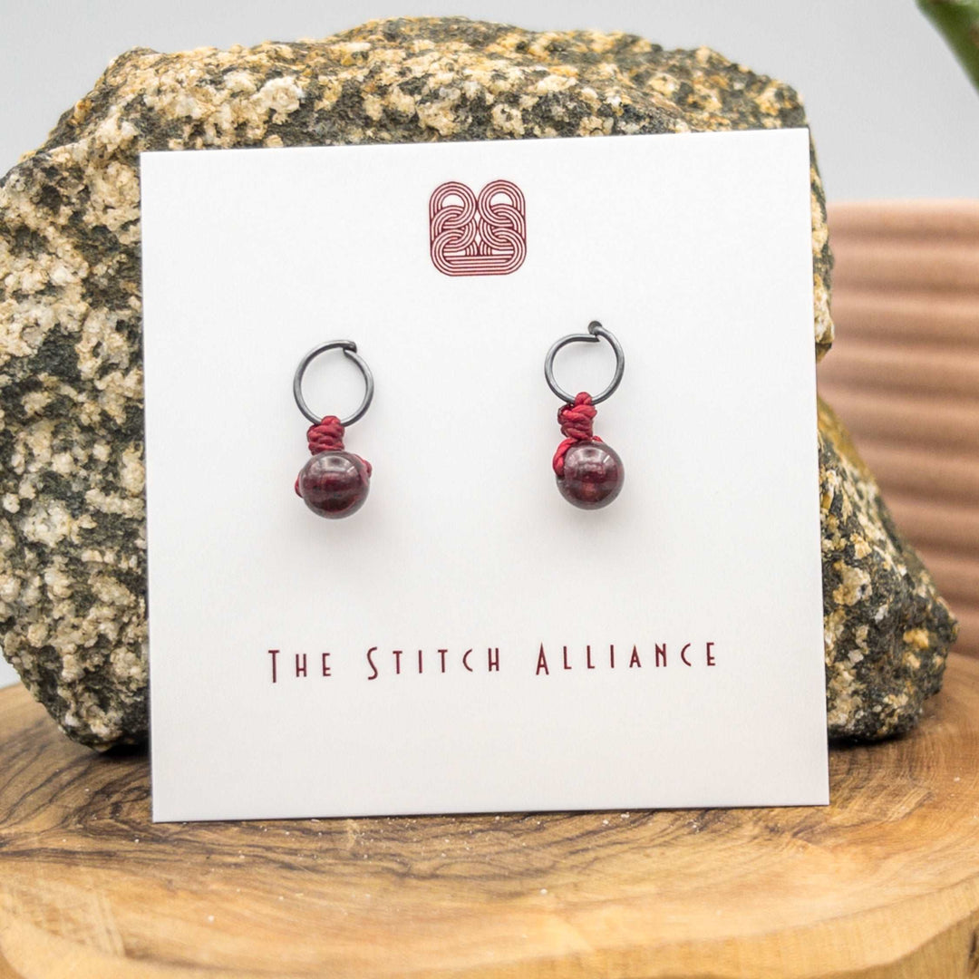 circle post style earrings handcrafted with oxidized sterling silver and a 6mm garnet bead
