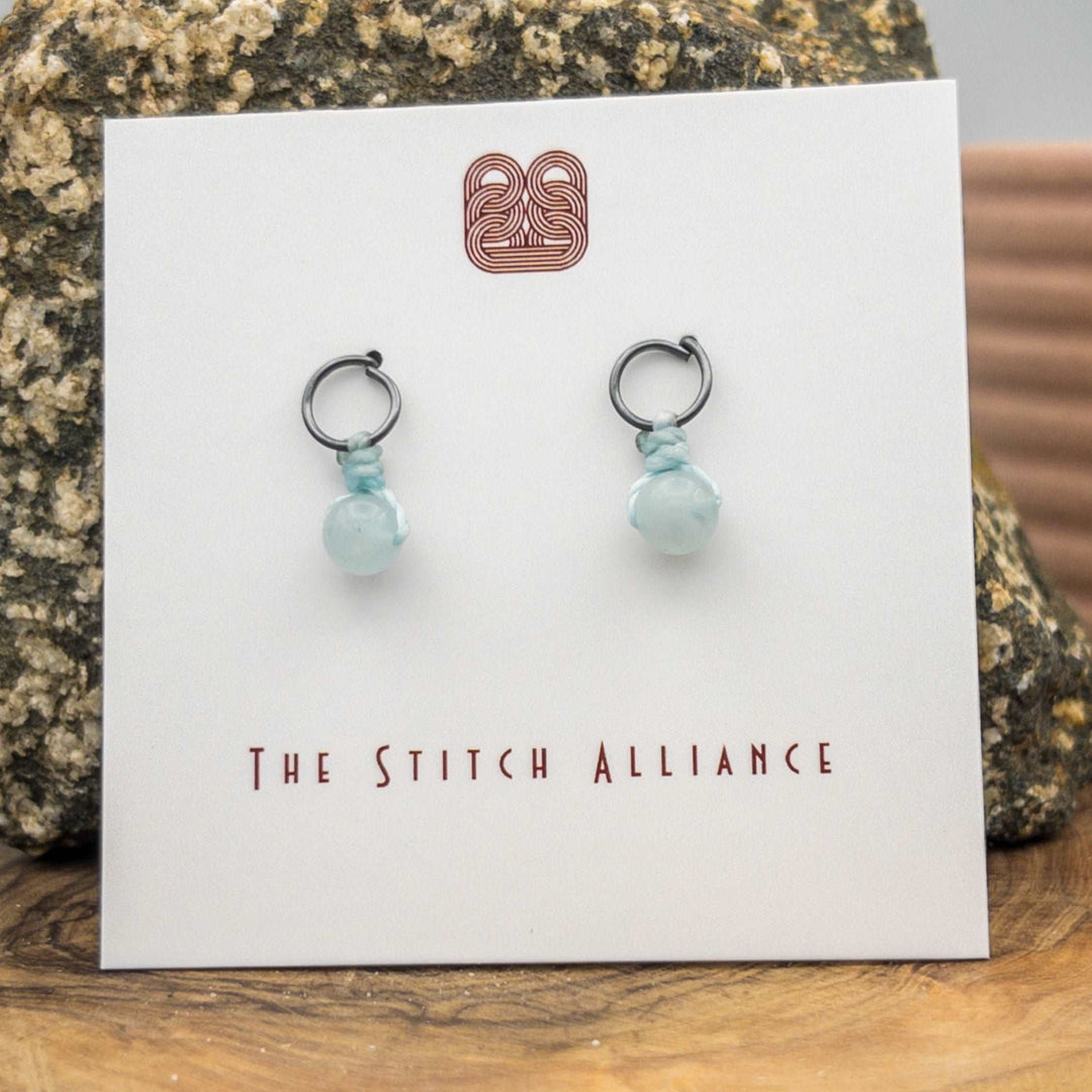 oxidized sterling silver post-style earrings with an aquamarine bead close up