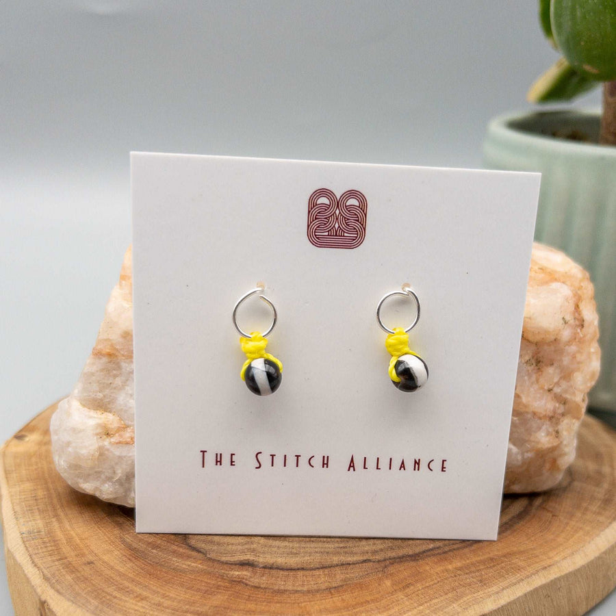 DZI bead earrings, sterling silver circle posts with bright yellow accents