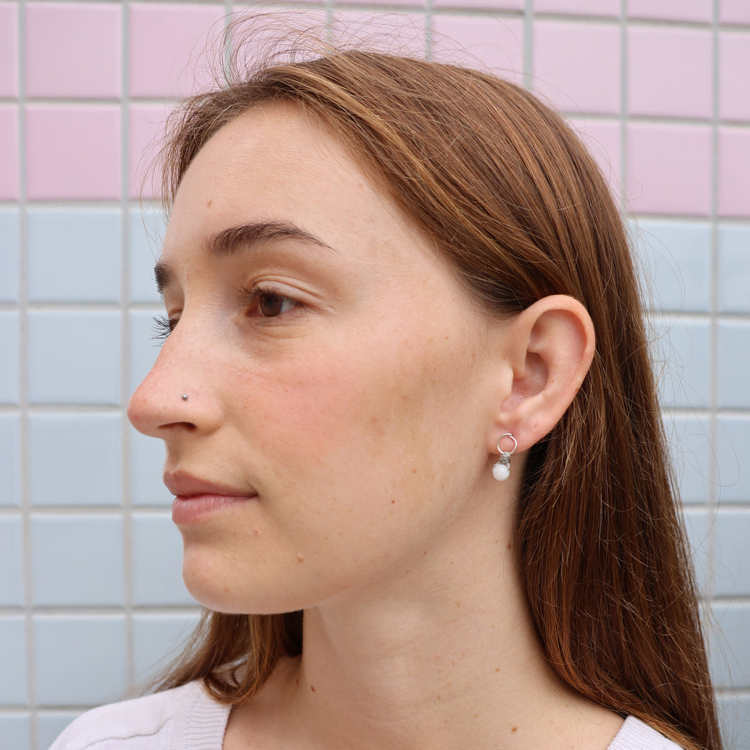 handmade moonstone and sterling silver earrings worn on model