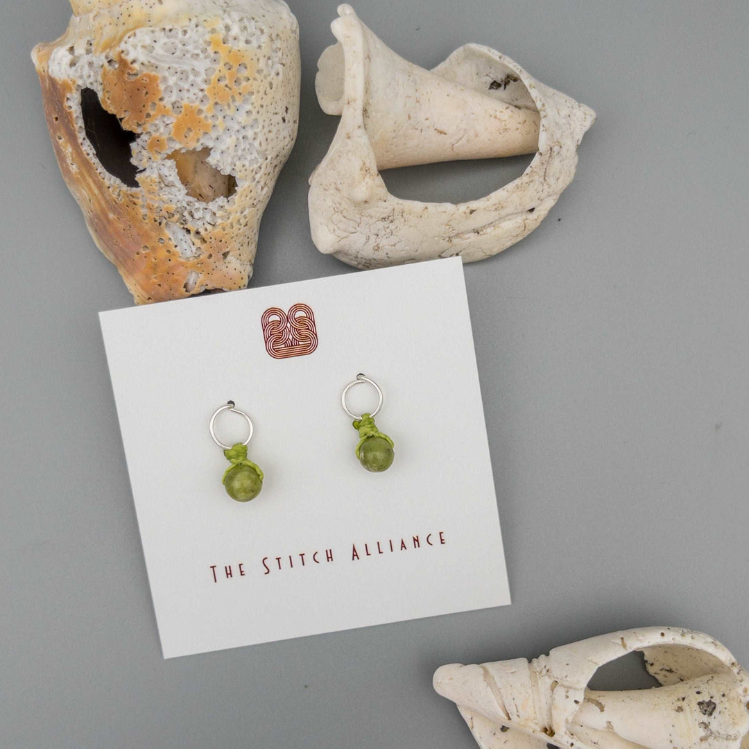 circle shaped sterling silver post earrings with peridot beads
