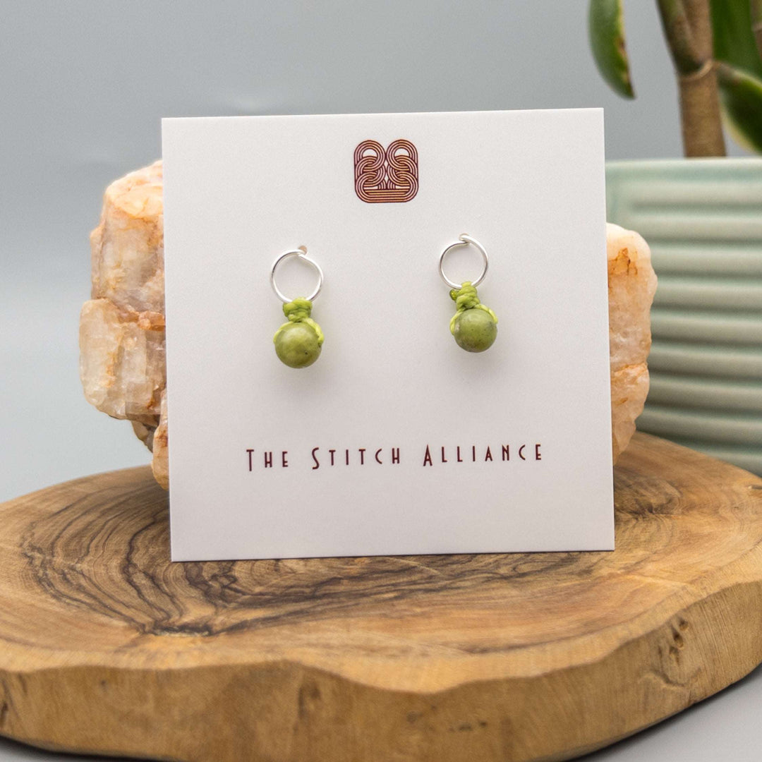 handcrafted circle shaped sterling silver post earrings with peridot beads