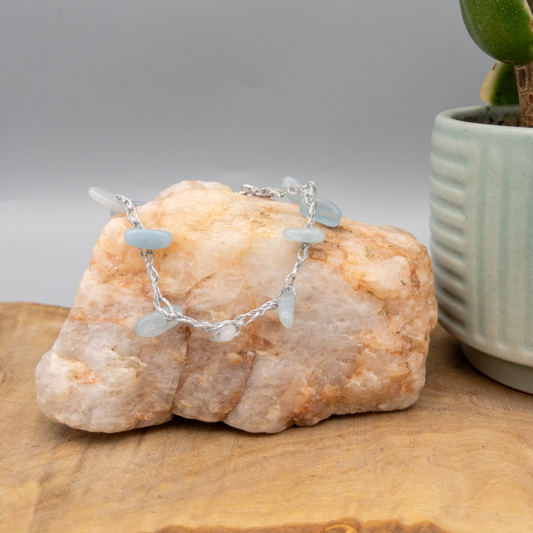 aquamarine crochet anklet with sterling silver clasp on a quartz rock