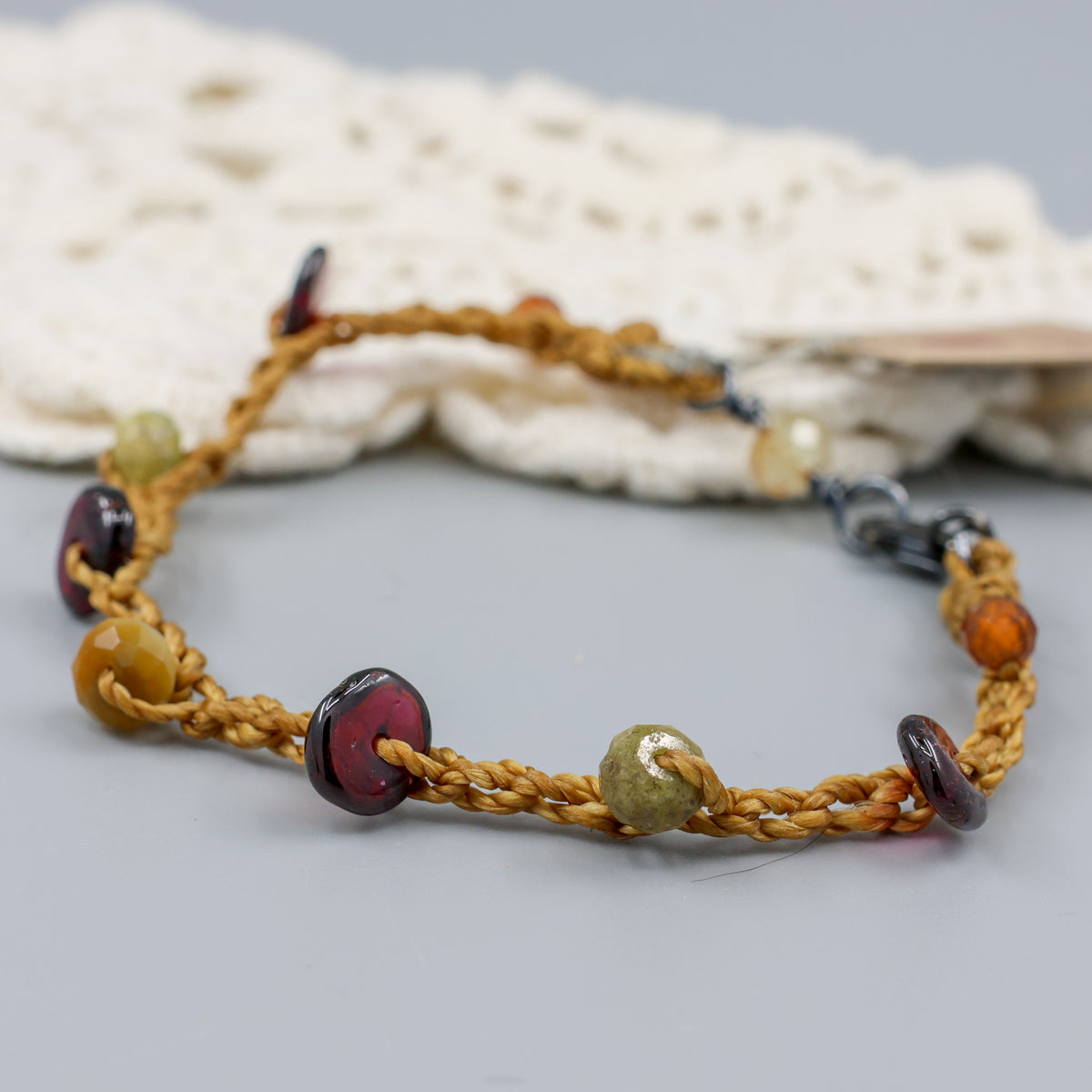 close up of handmade garnet crochet bracelet