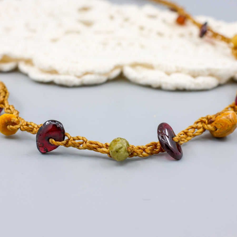 close up view handmade crochet necklace with garnet beads and oxidized sterling silver clasp