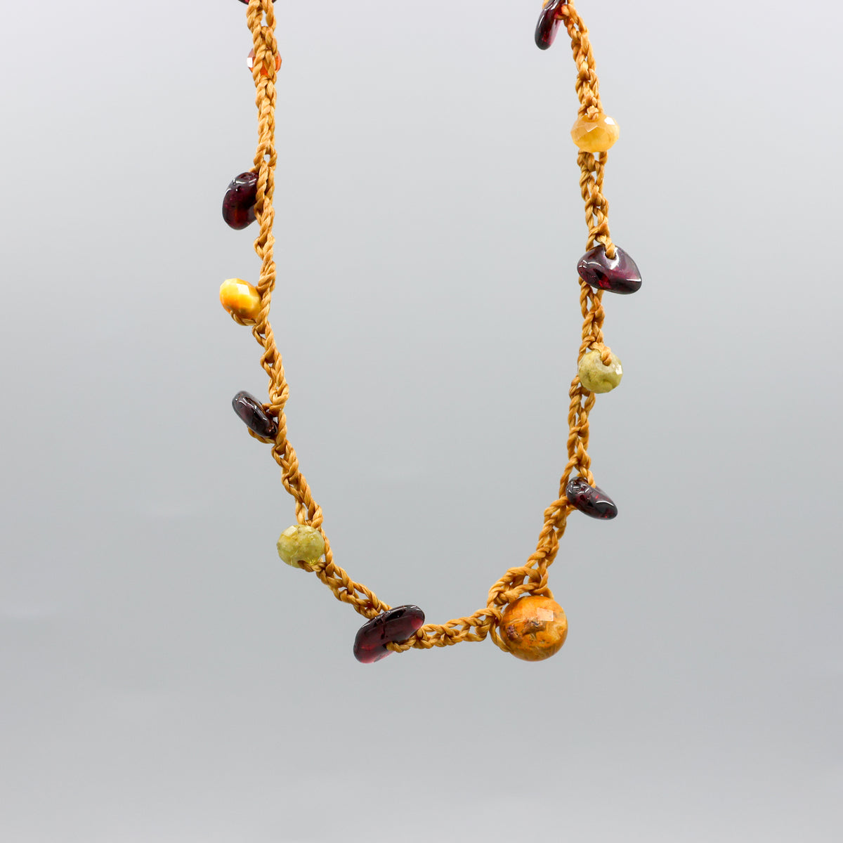 handmade crochet necklace with garnet beads and oxidized sterling silver clasp