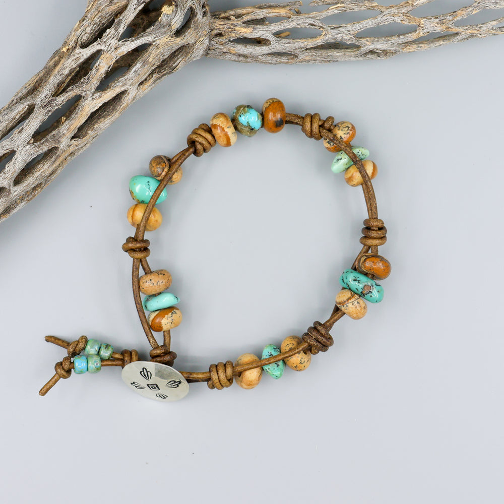 overhead view handmade jasper and turquoise leather bracelet with sterling silver button clasp