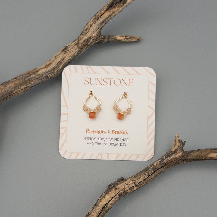 gold filled square sunstone earrings with macrame on a gray background