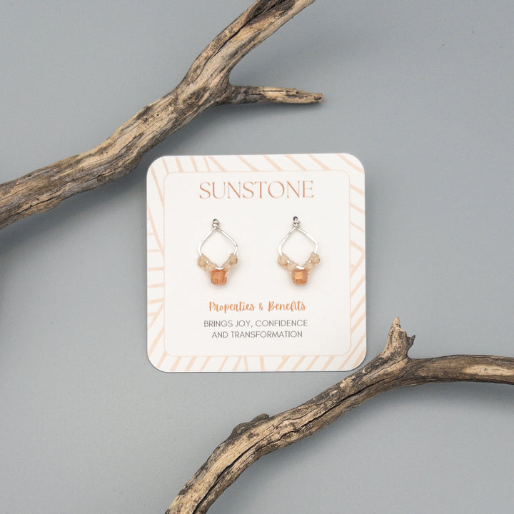 square sterling silver sunstone macrame earrings on a gray background