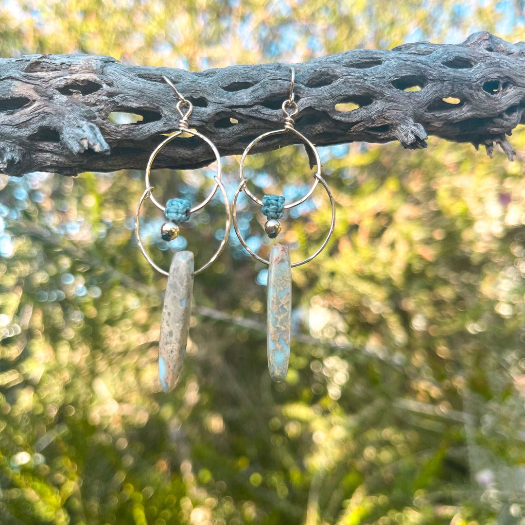 14k gold filled double hoop earrings with aqua terra jasper beads hanging from a chola branch