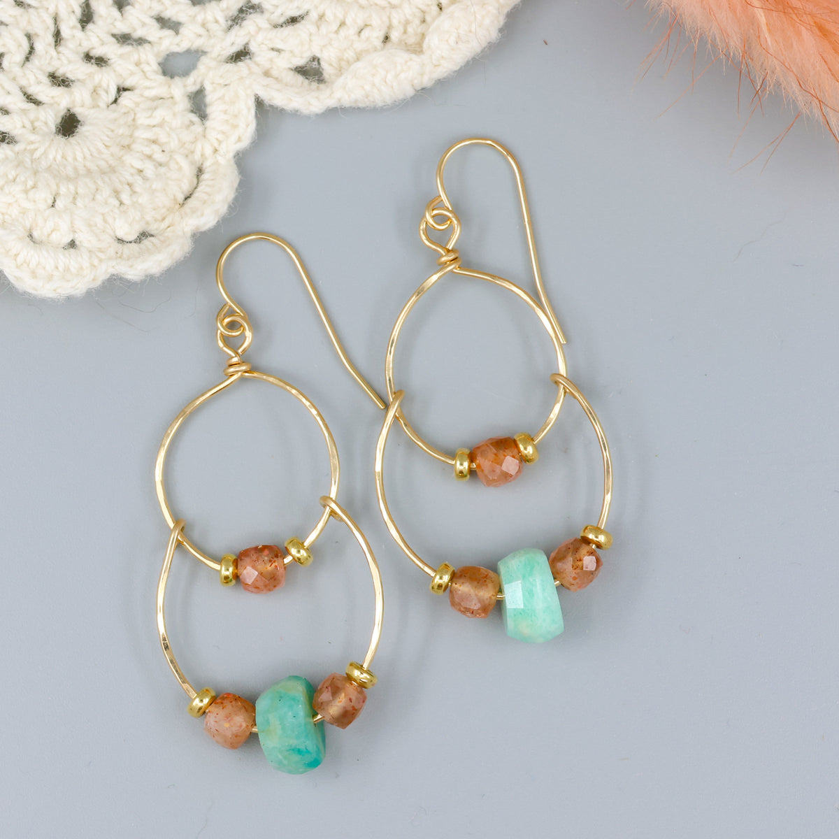 handmade gold fill double hoop earrings with amazonite and sunstone beads on a gray background