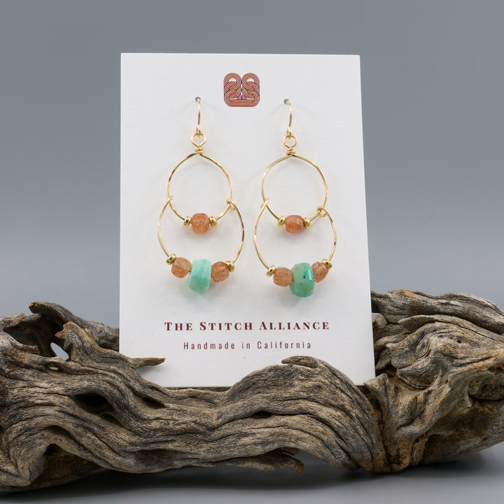 handmade gold fill double hoop earrings with amazonite and sunstone beads on a white card