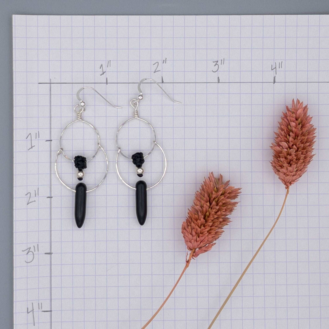 Size details of Sterling silver double hoop earrings. Handcrafted and hand-hammered with black howlite spike shaped beads.
