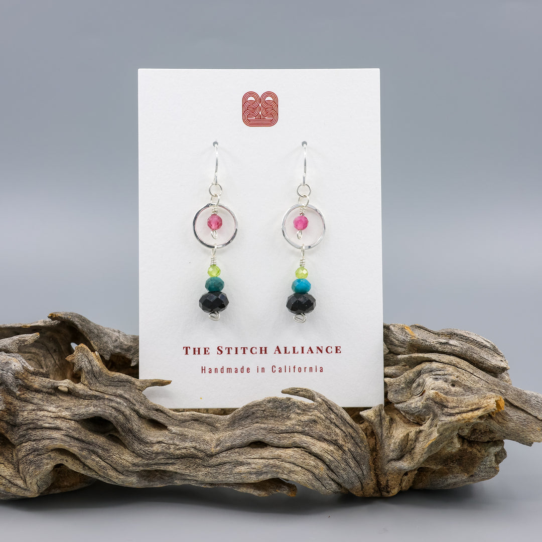 handmade sterling silver and gemstone earrings with black tourmaline, apatite, peridot, and pink tourmaline on a white card