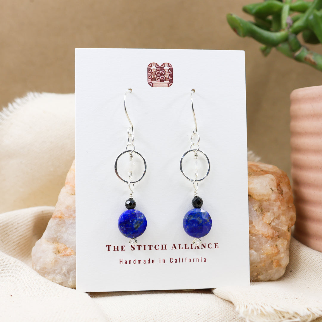 lapis lazuli, black spinel, and rainbow moonstone sterling silver earrings on a white card