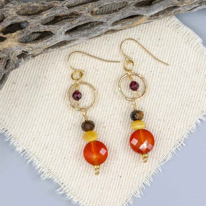 carnelian, golden tiger's eye, and garnet gold filled handmade dangle earrings on off white background