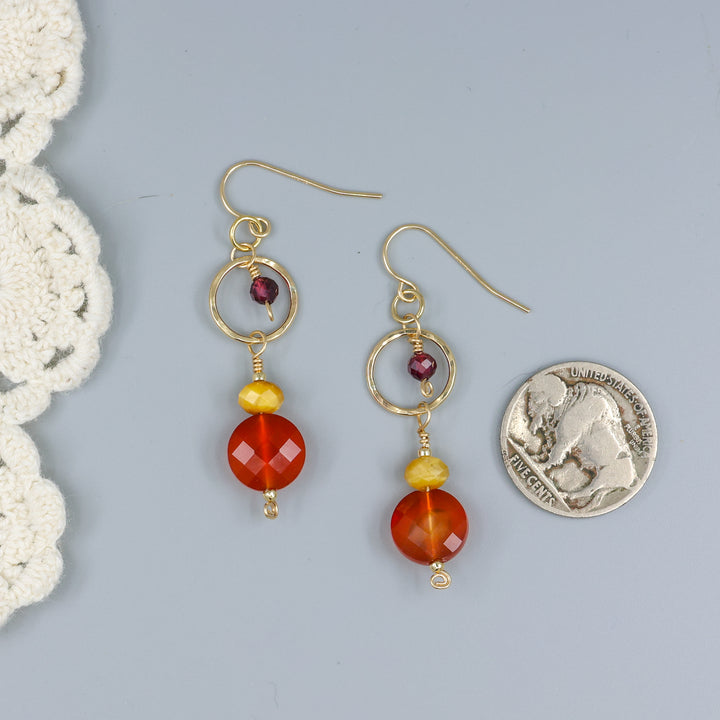 Carnelian, tiger's eye, and garnet gold filled dangle earrings with a nickel for size comparison