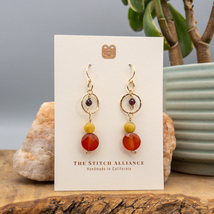 gold filled carnelian, golden tiger's eye, and garnet  dangle earrings on a white card