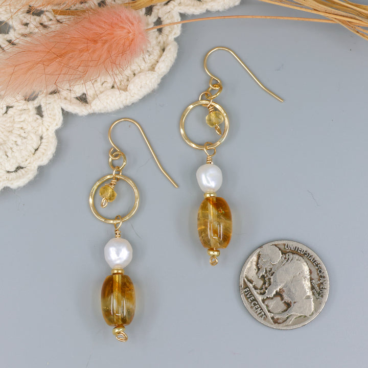 handmade gold fill earrings with citrine and freshwater pearl beads with a nickel for size comparison