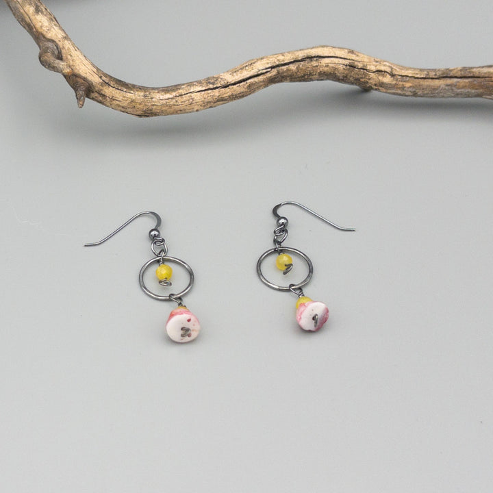 Spiny oyster, yellow opal, and oxidized sterling silver handmade earrings on a gray background