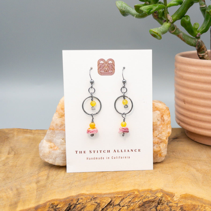 Spiny oyster, yellow opal, and oxidized sterling silver handmade earrings on a white card