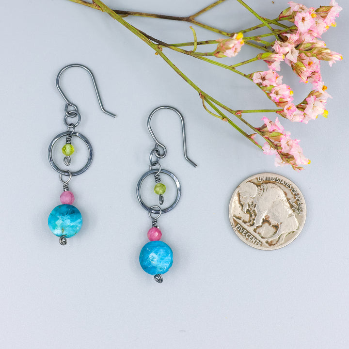 handmade gemstone and oxidized sterling silver earrings with apatite, pink tourmaline, and peridot with a nickel for size comparison