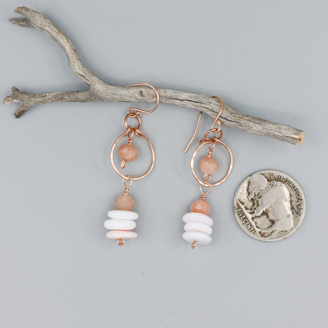 queen conch and peach moonstone rose gold dangle earrings with coin for size comparison