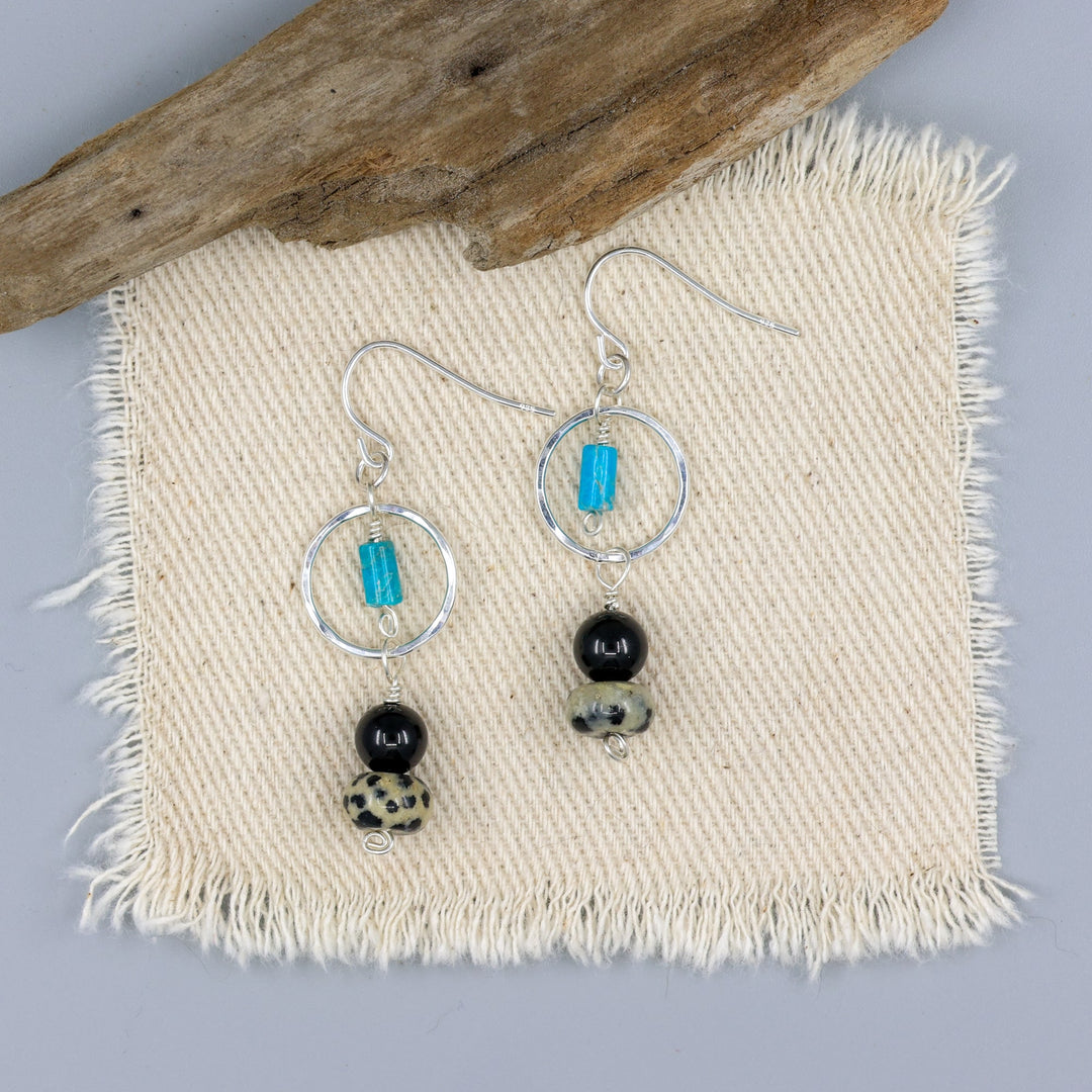 handmade dalmation jasper, spinel, and turquoise sterling silver dangel earrings on an off white background