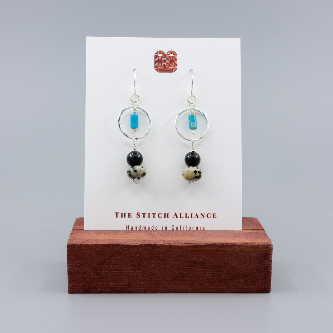 handmade dalmation jasper, spinel, and turquoise sterling silver dangel earrings on a white card