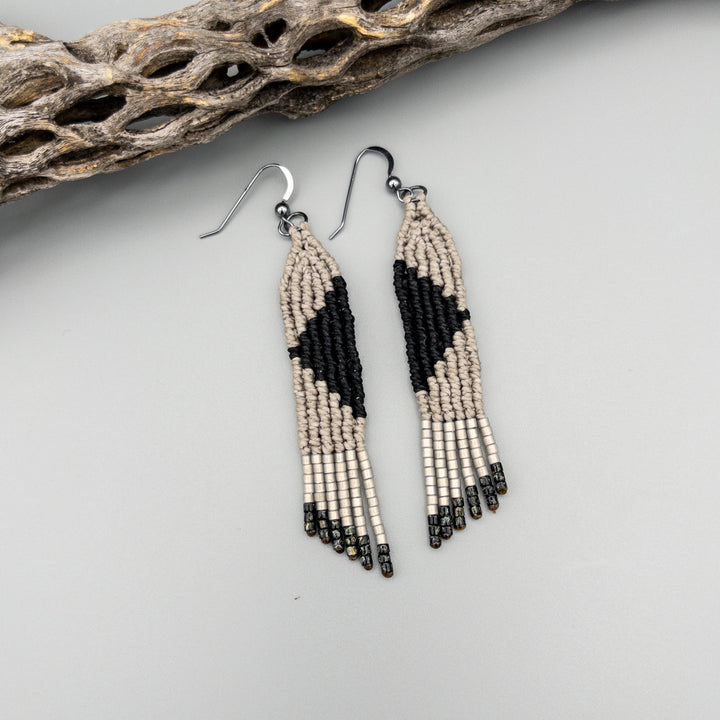 handmade macrame earrings in gray and black with oxidized sterling silver earring wires on a gray background
