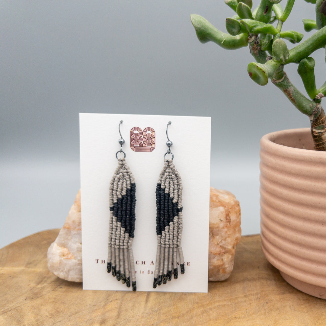 handmade macrame earrings in gray and black with oxidized sterling silver earring wires on a white background