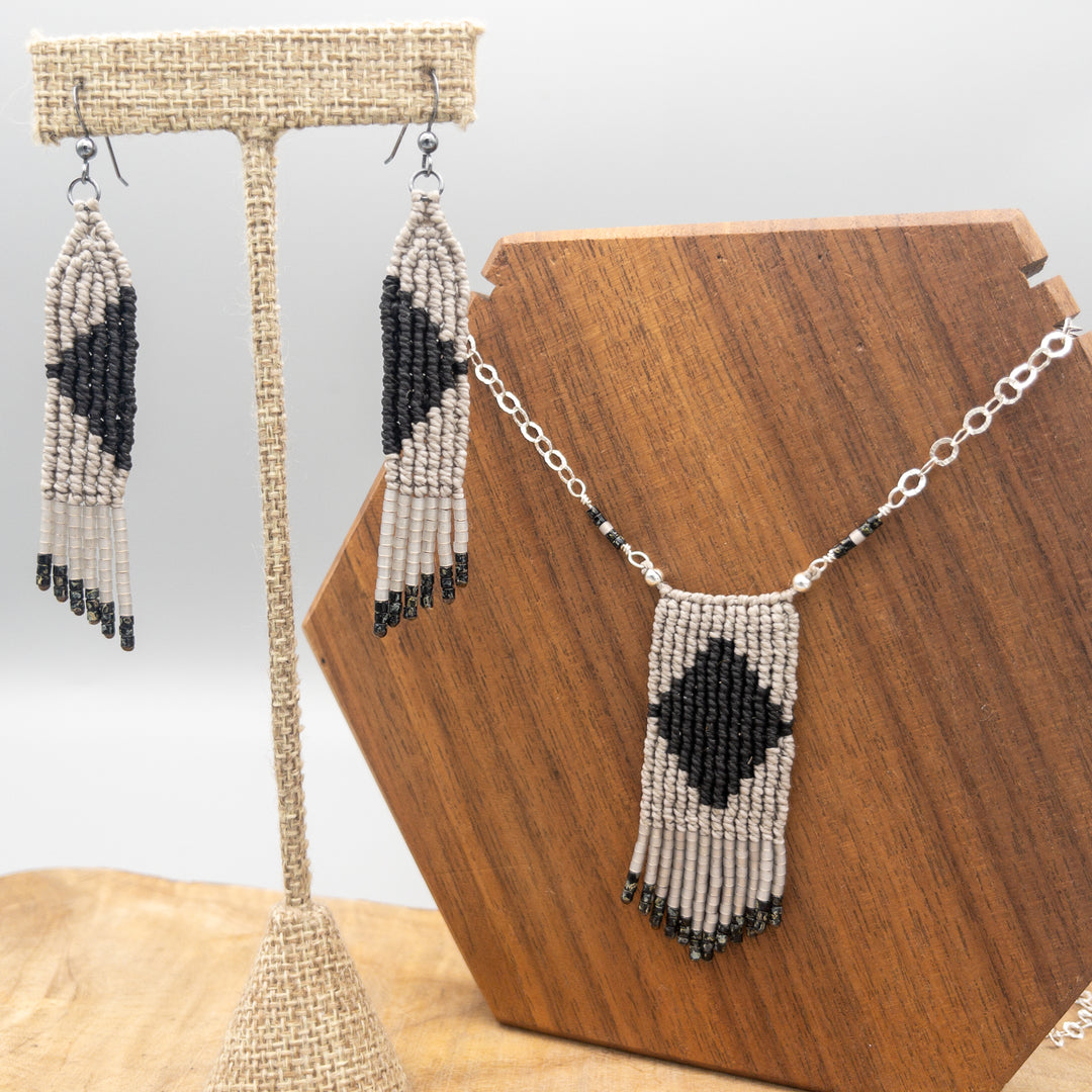 black and gray macrame necklace with seed bead fringe and sterling silver chain shown with matching earrings