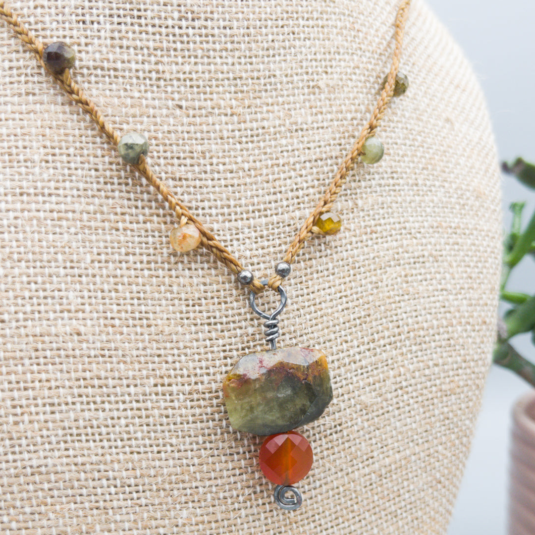 close up view of green garnet and carnelian amulet necklace