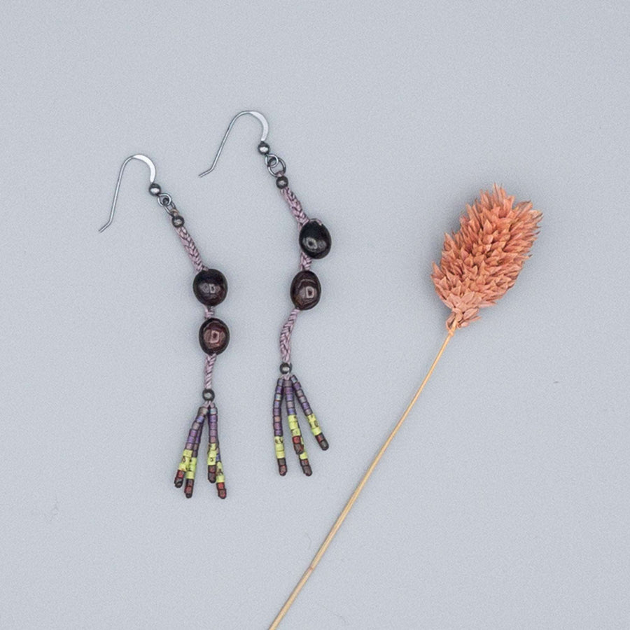 garnet dangle earrings with seed bead fringe on a gray background