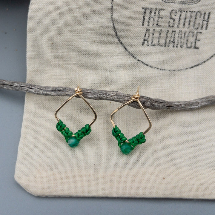 Gemini green agate earrings in gold fill  on a muslin bag