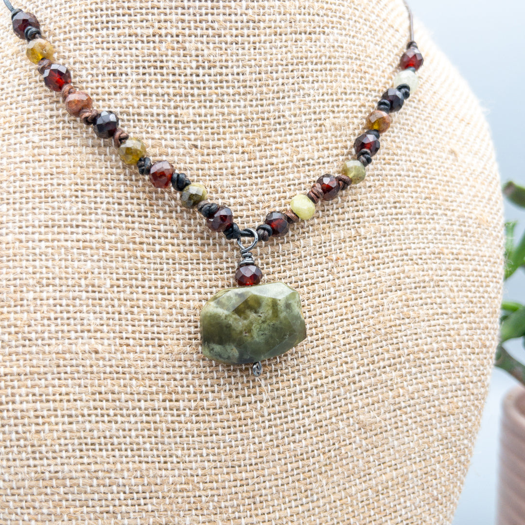 Green and red garnet leather knotted necklace close up