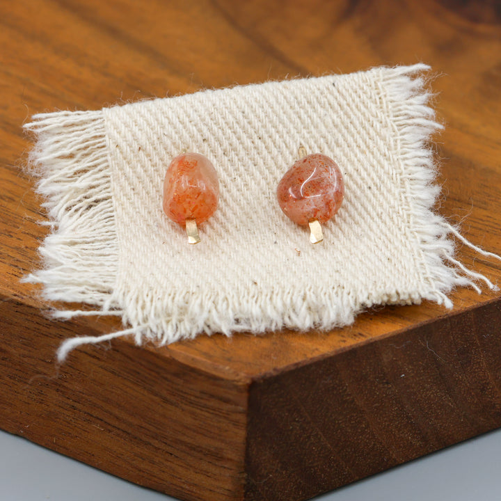 handmade sunstone gold fill stud earrings on a wood display