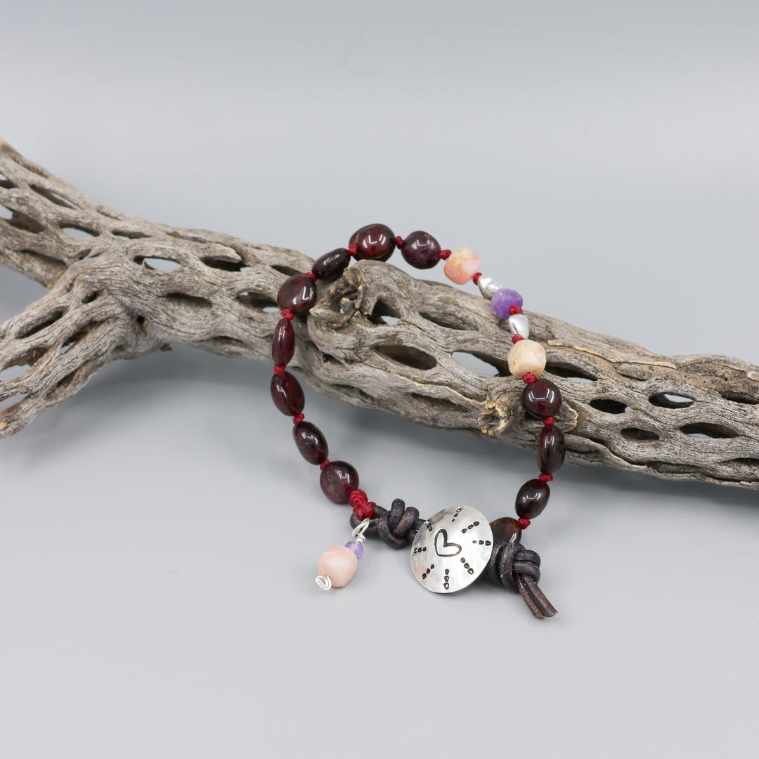 handmade heart stamp bracelet with garnet, amethyst, and pink opal beads