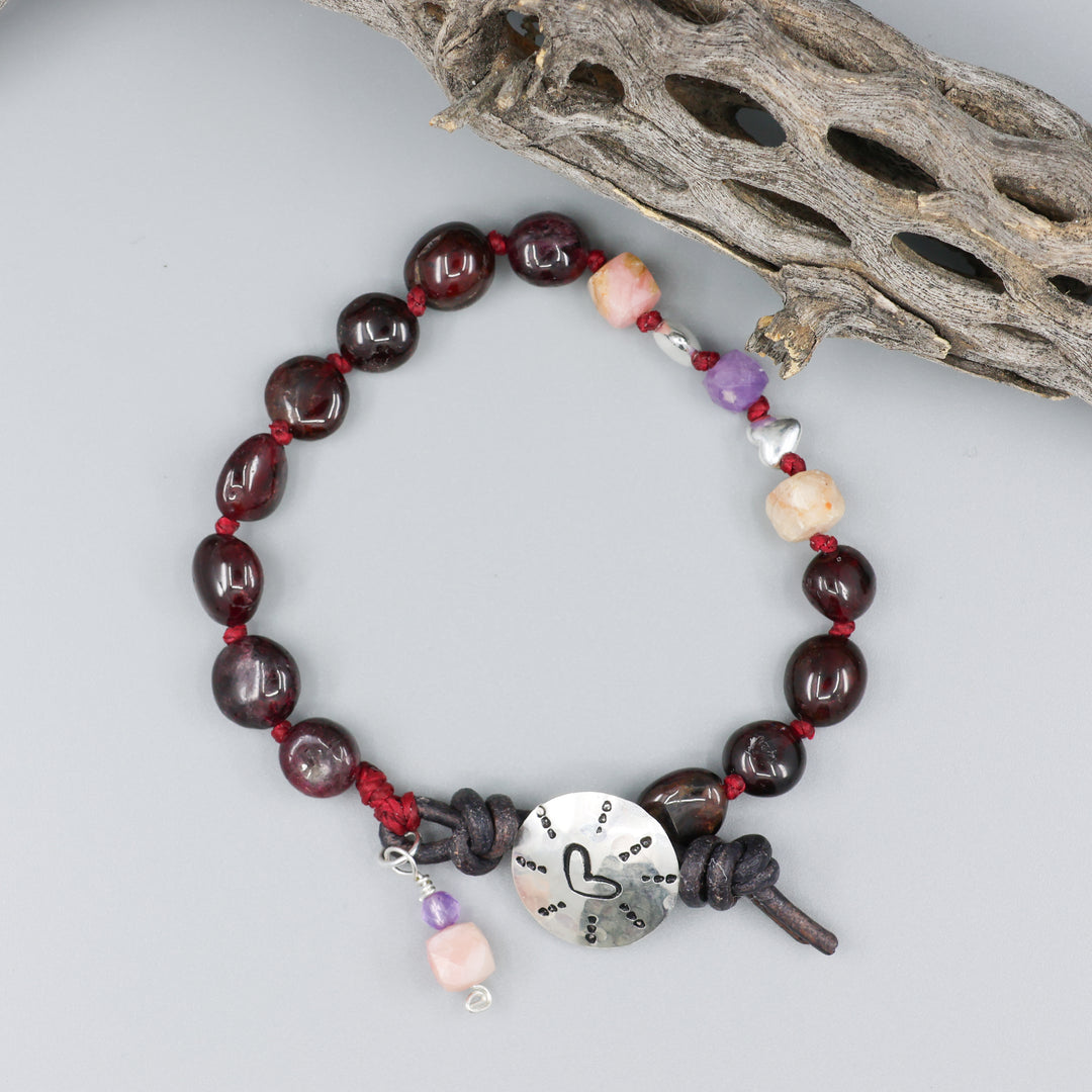 heart stamp bracelet with garnet, amethyst, and pink opal beads