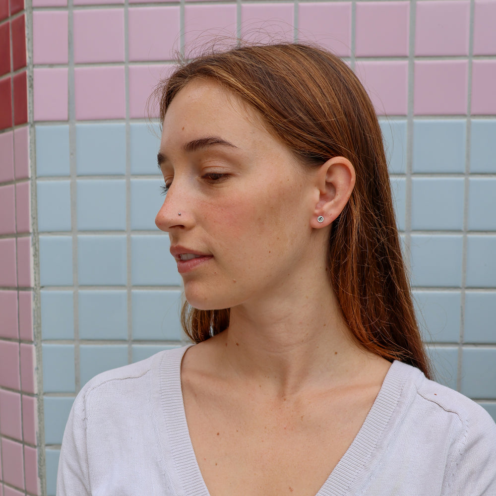 heart stud sterling silver earrings worn on a model